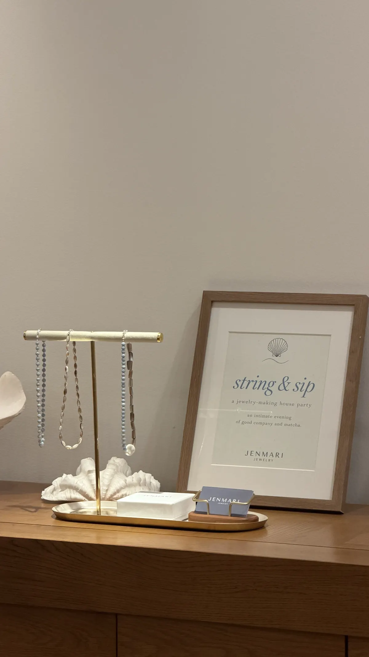 The framed string & sip invitation on the sideboard
