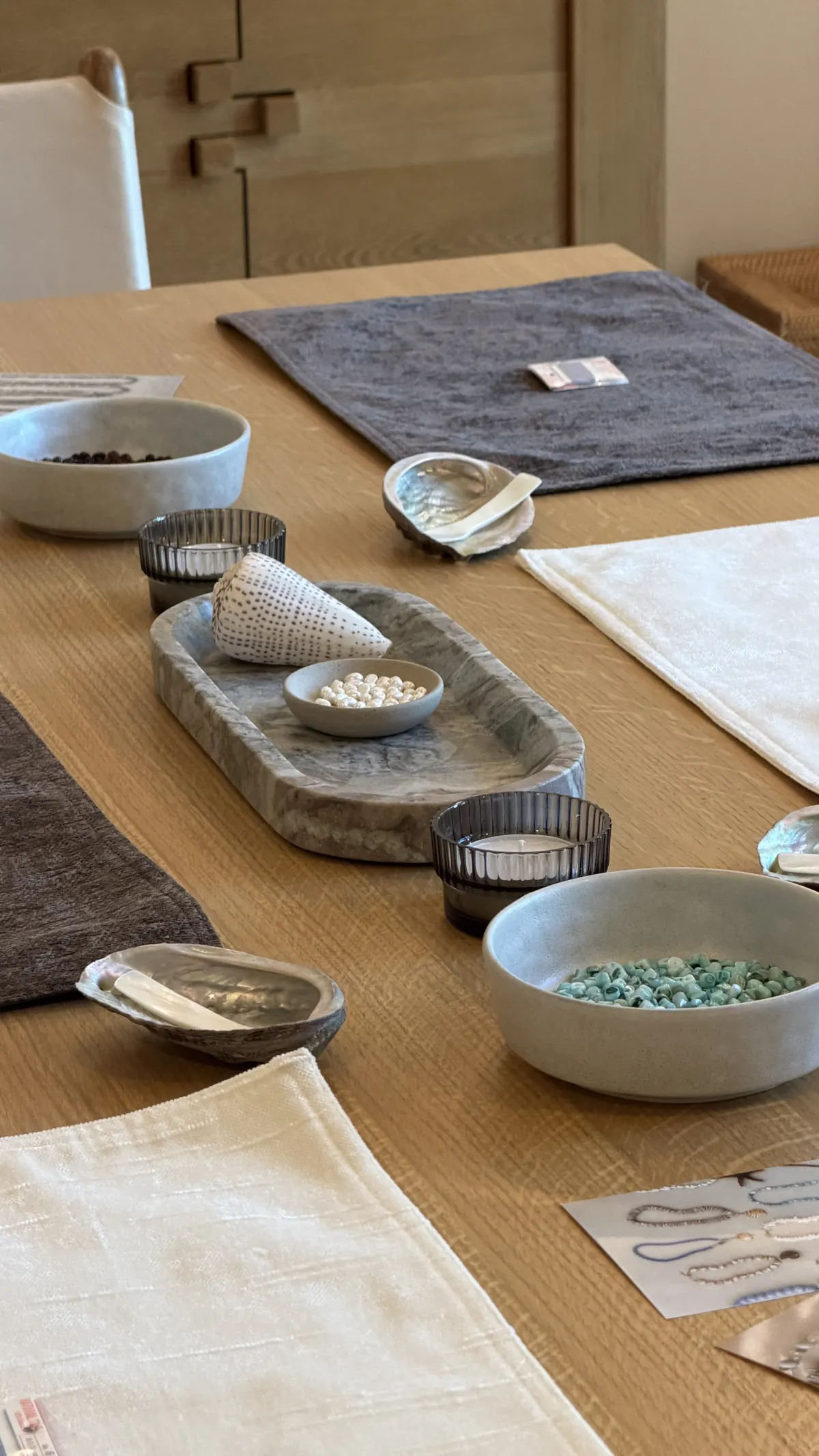 A place setting with bowls of pearls and sea-glass beads