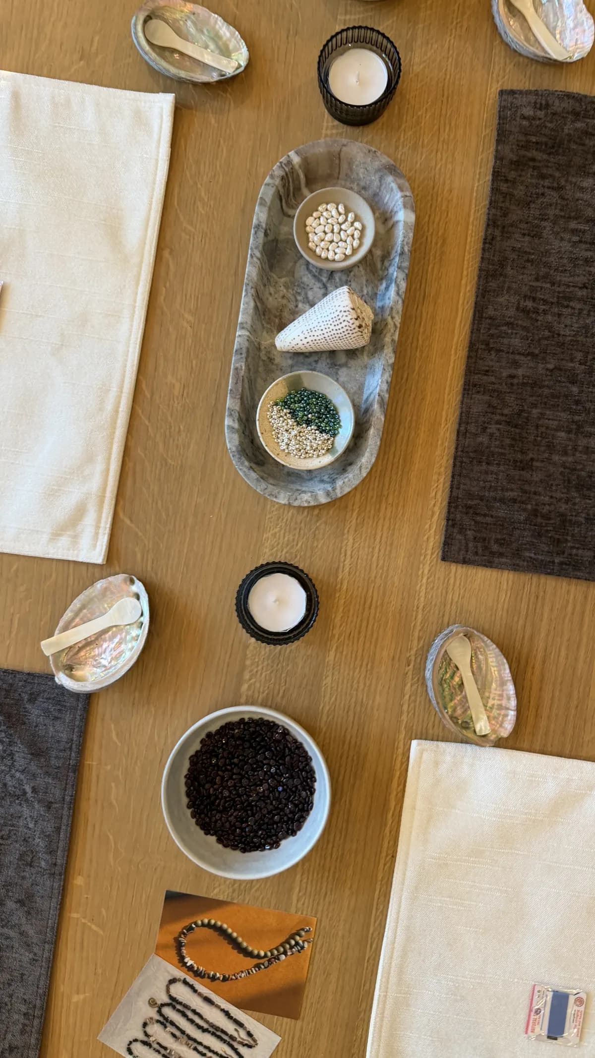 The table from above, set with shells, beads and candles